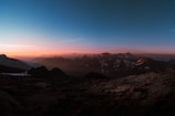 A breathtaking mountain landscape at sunset, showcasing vibrant colors and a tranquil atmosphere.