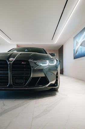 Minimalist car showroom with sleek vehicles lined up under soft lighting