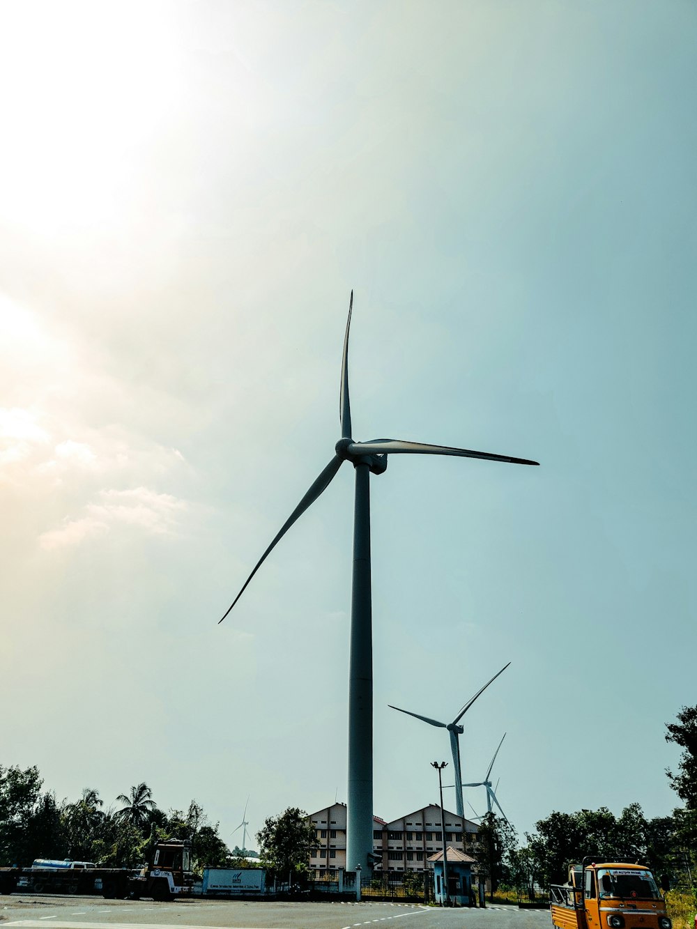 a truck driving past a wind turbine on a road