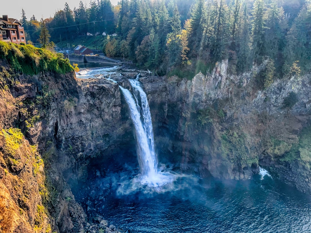 a waterfall with a house on top of it