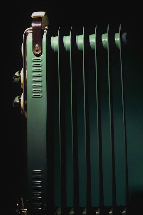 A close-up of a radiator being repaired in a workshop.