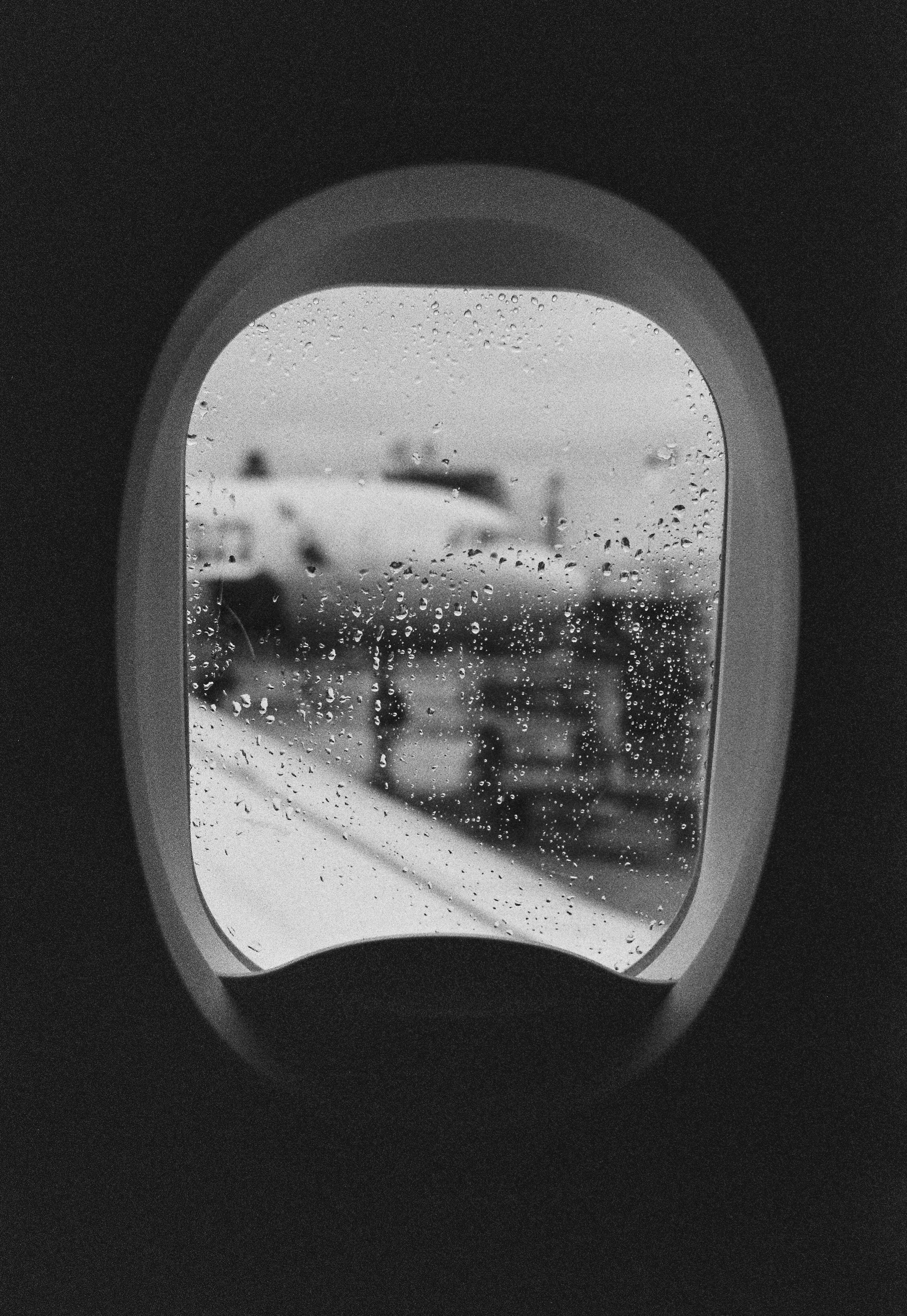 an airplane window with a view of a train