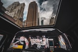 A scenic view of a taxi driving through a cityscape.