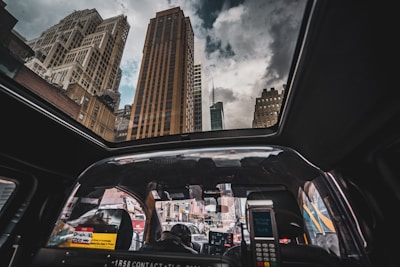 A scenic view of a taxi driving through a cityscape.