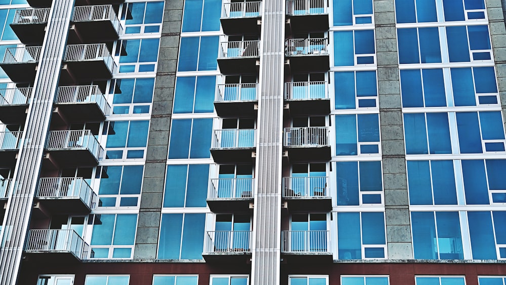 a tall building with lots of windows and balconies