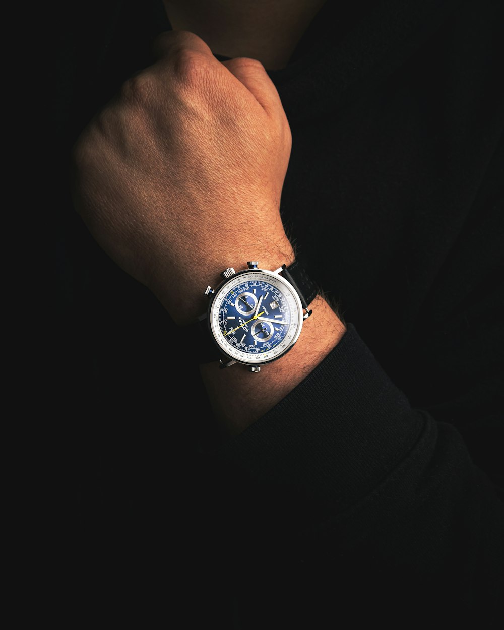 a close up of a person wearing a watch