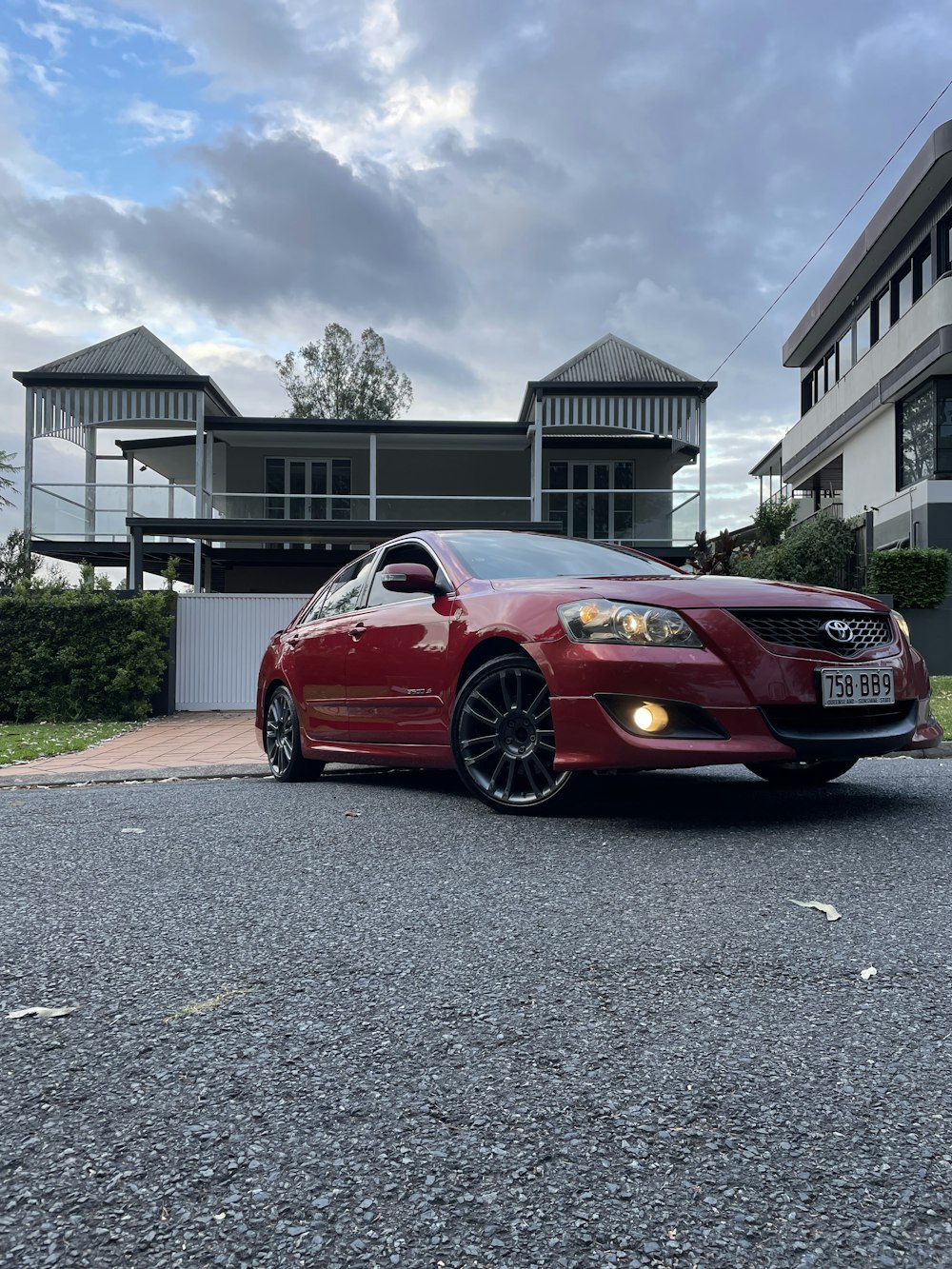 a red car parked in front of a house