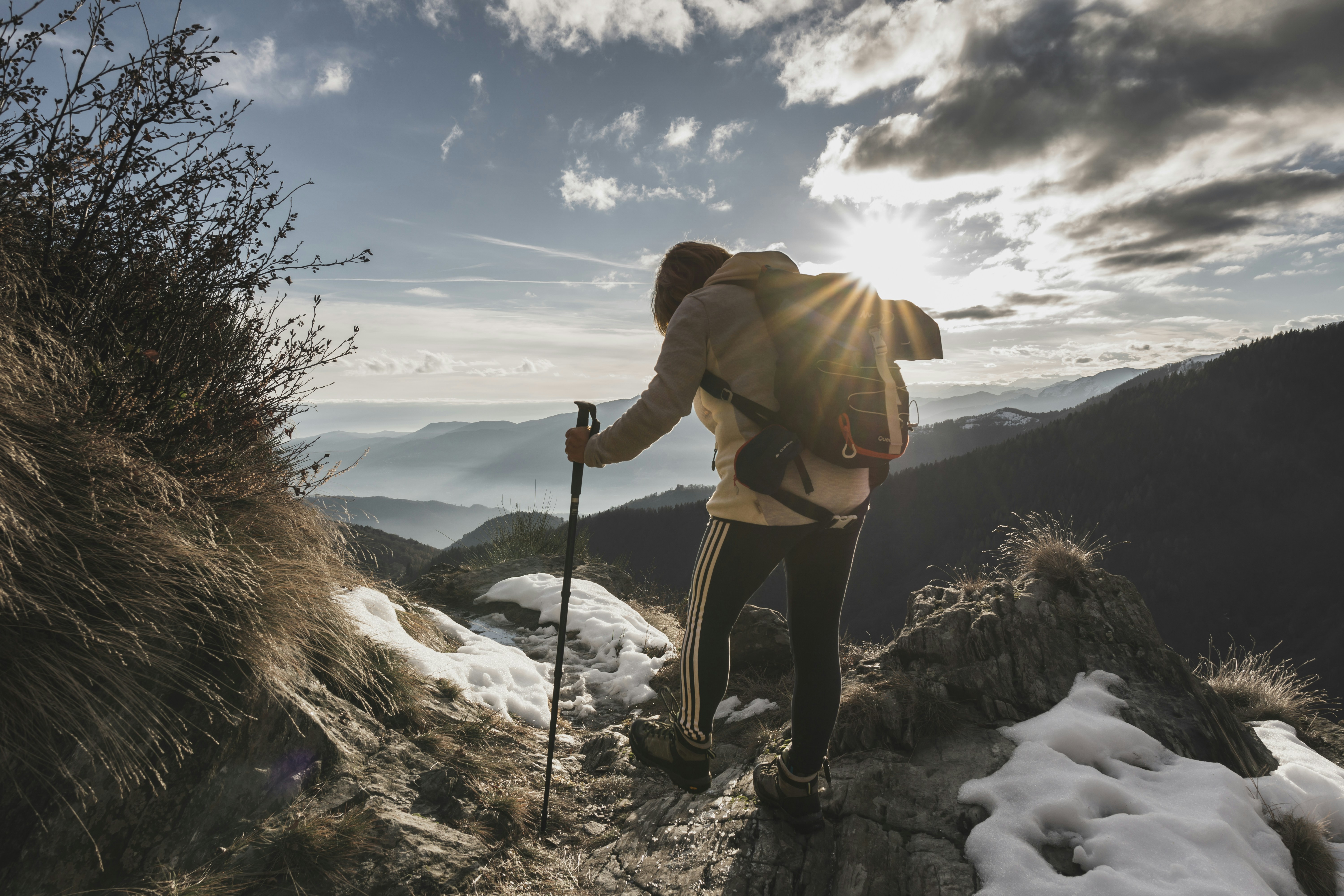 a man hiking up a mountain with a backpack