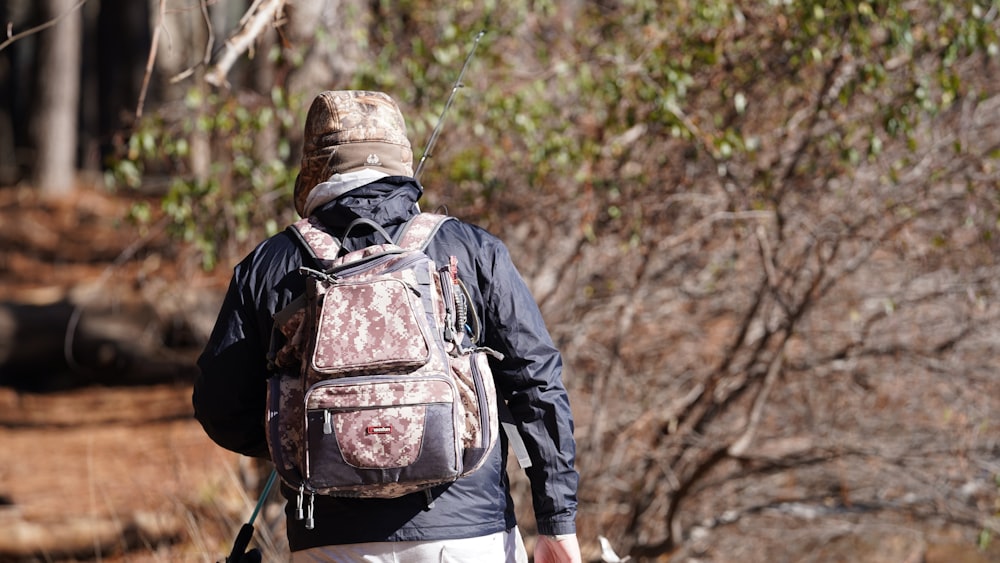 a man with a backpack walking in the woods