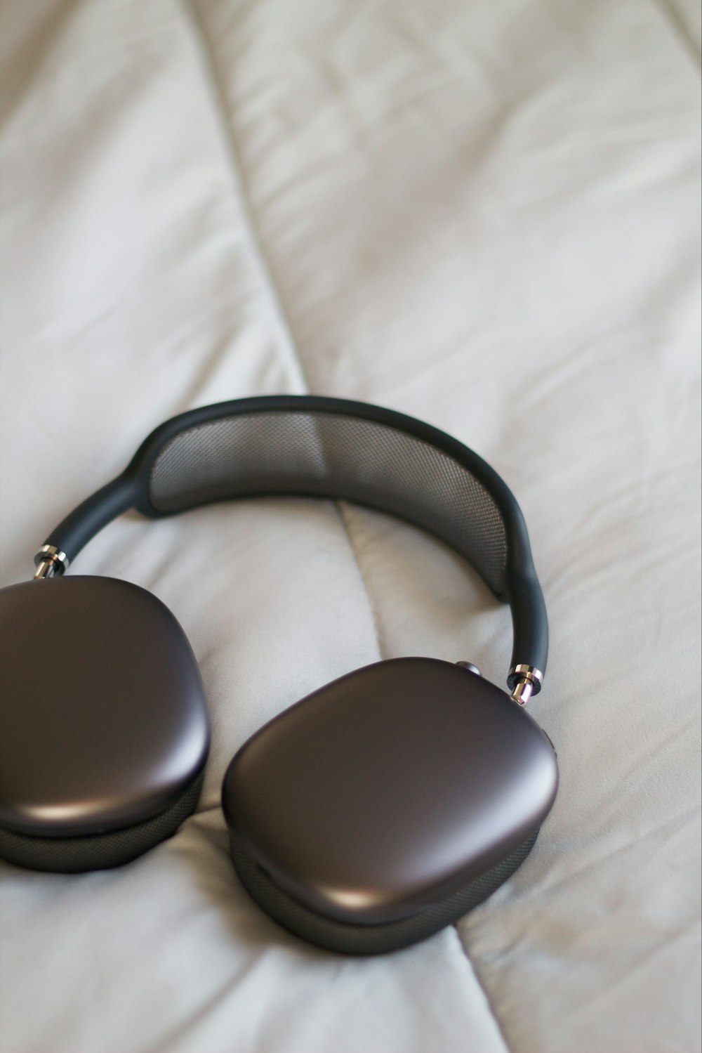 a pair of headphones sitting on top of a bed