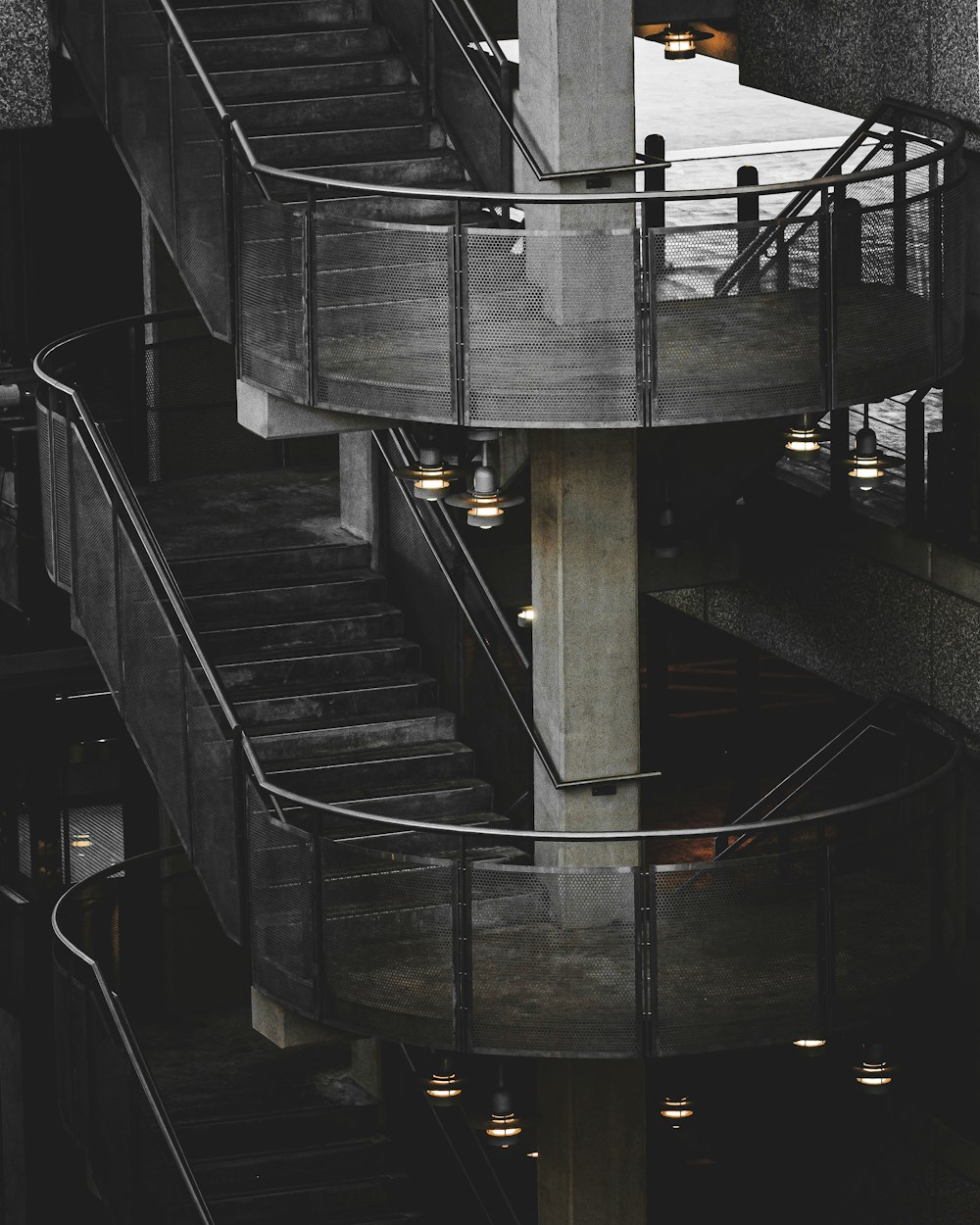 a spiral staircase in a building with lights on it