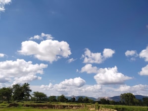 A picturesque Texas landscape featuring a ranch and open fields under a clear blue sky.