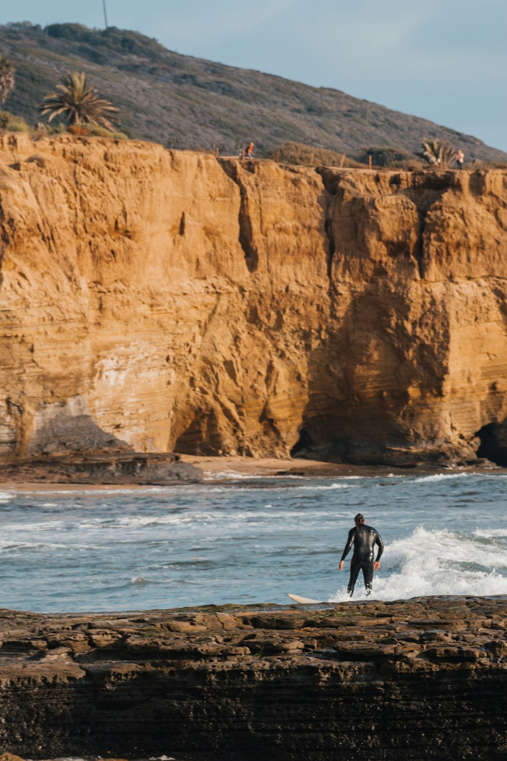 a man riding a wave on top of a surfboard