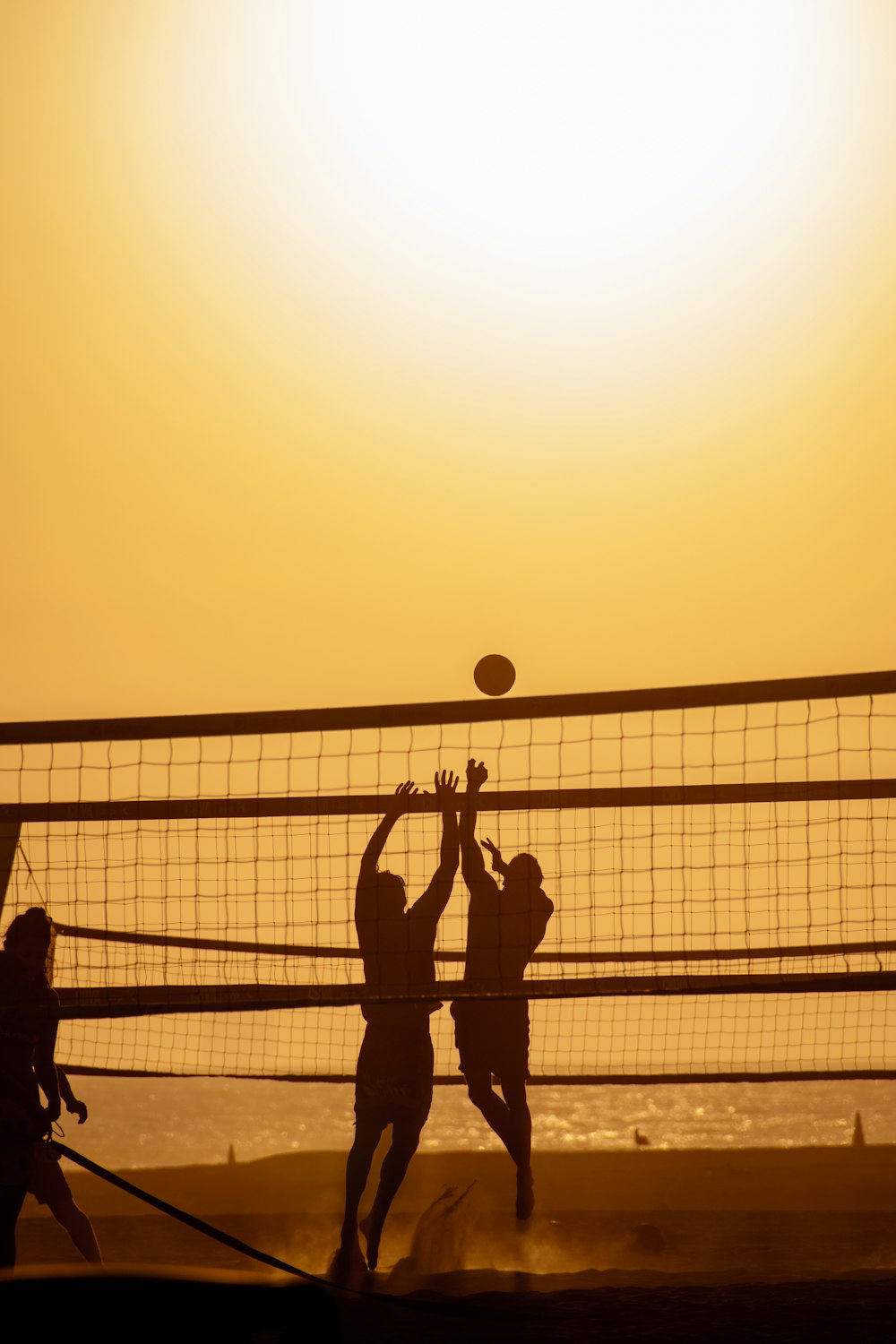 a group of people playing a game of volleyball