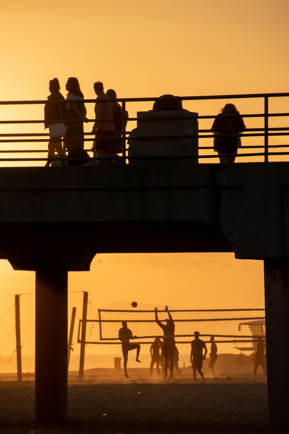 a group of people standing on top of a bridge