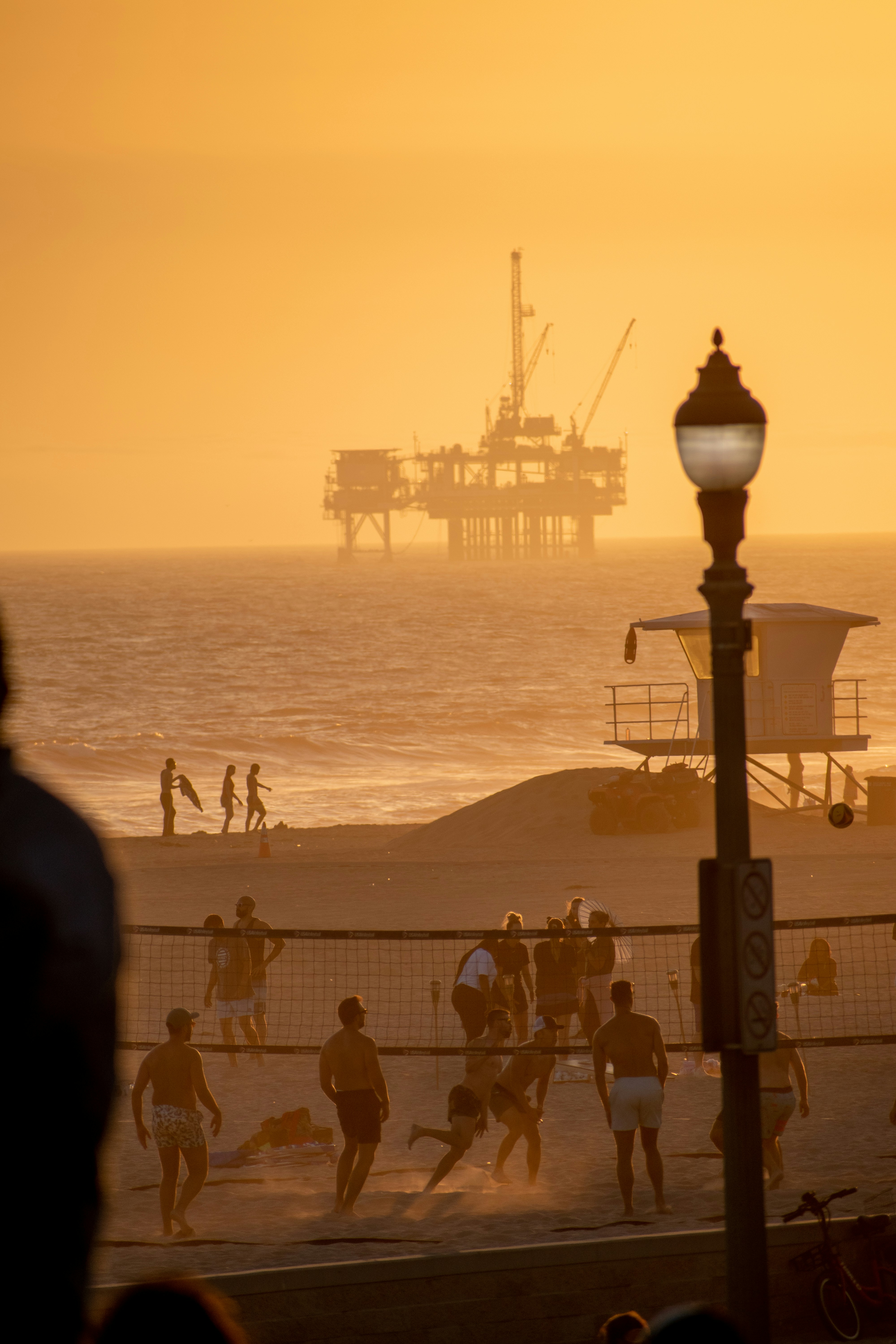 a group of people playing volleyball on the beach