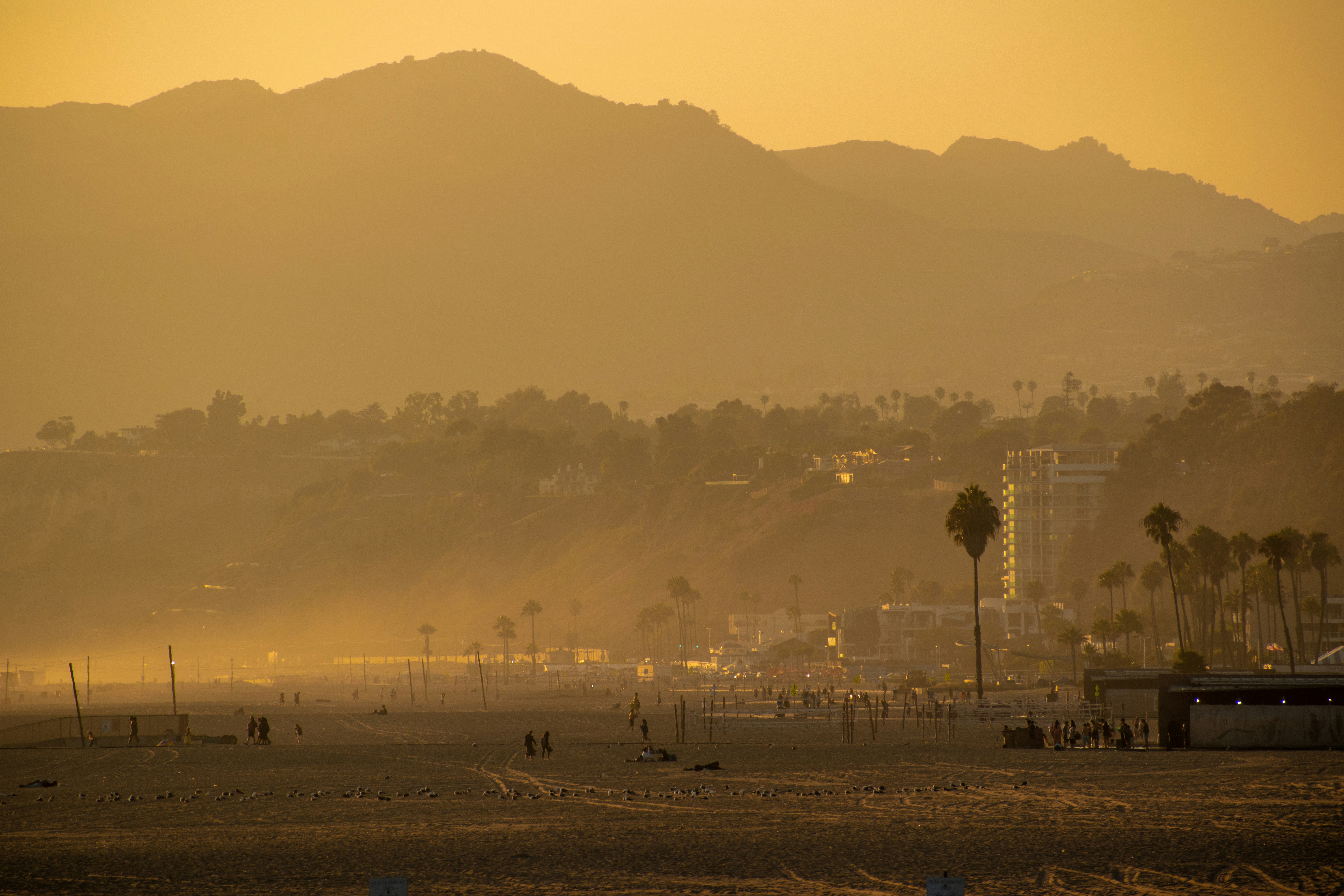 a view of a beach with mountains in the background