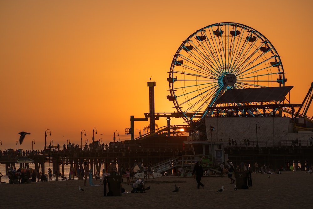 a ferris wheel sitting on top of a sandy beach