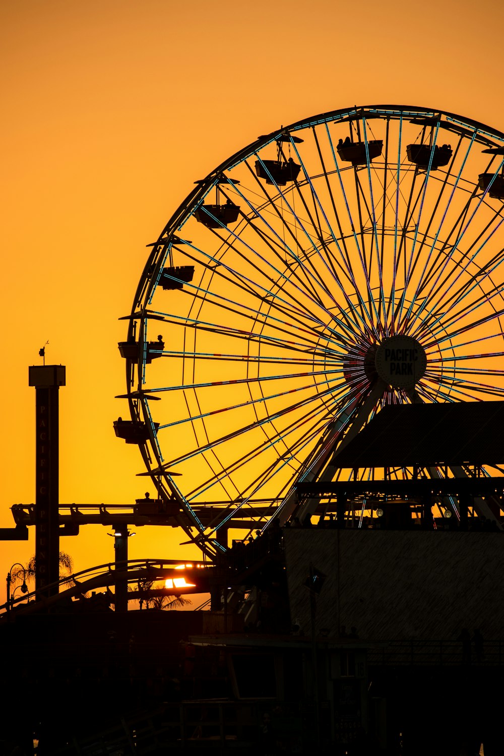 a large ferris wheel sitting next to a tall building