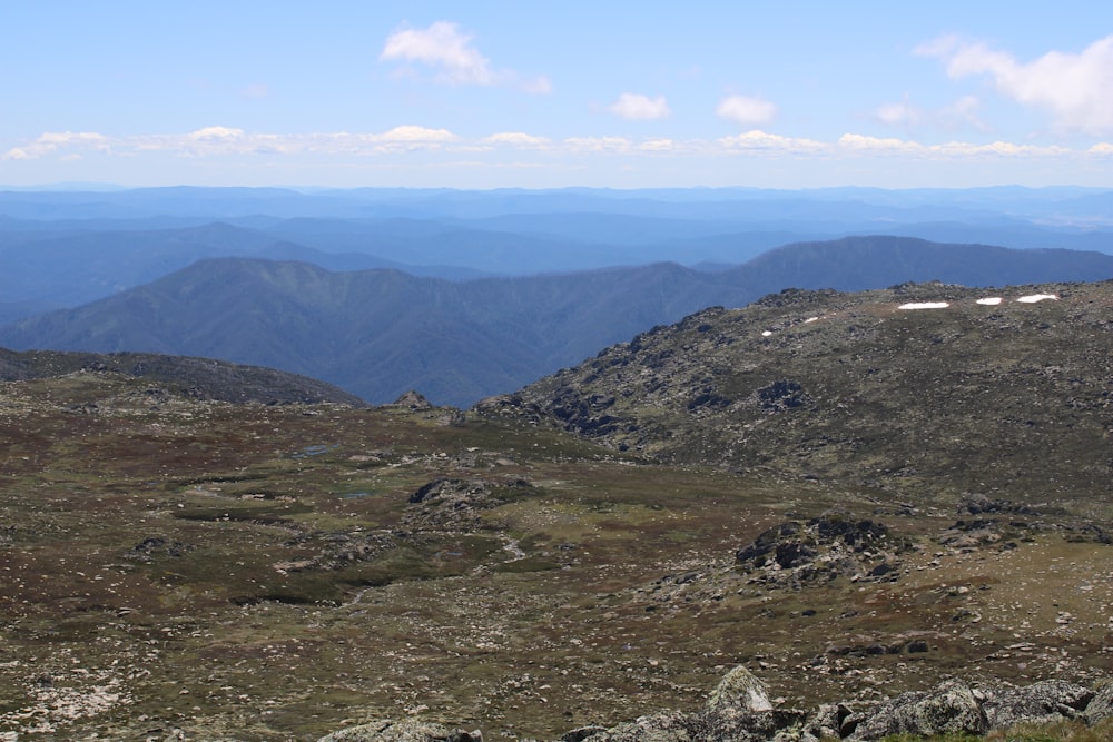 a view of mountains from the top of a hill