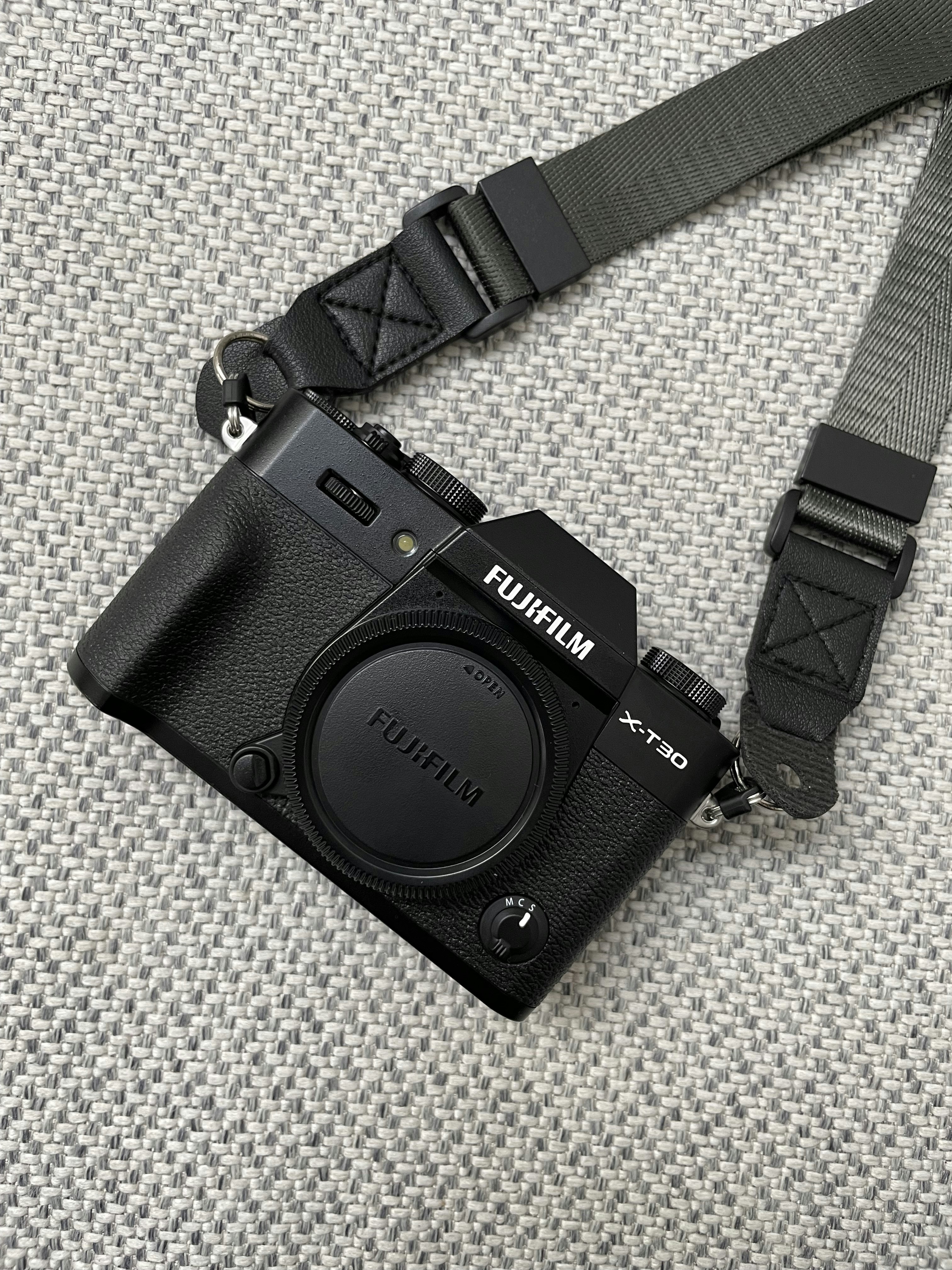 a black camera sitting on top of a gray blanket