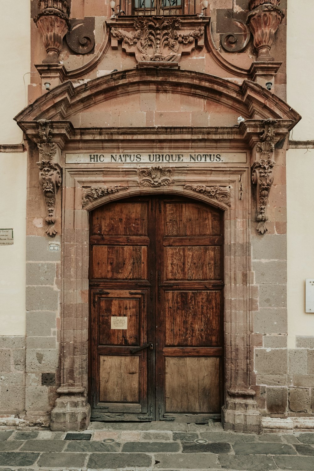 an old building with two large wooden doors