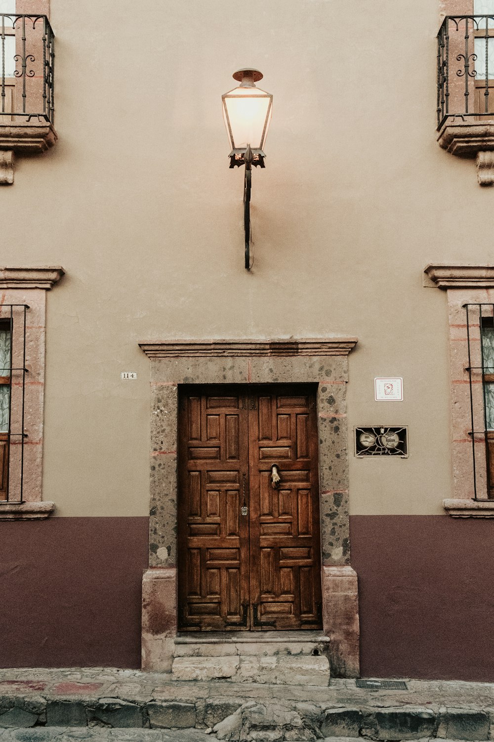 a building with two doors and a light on top of it