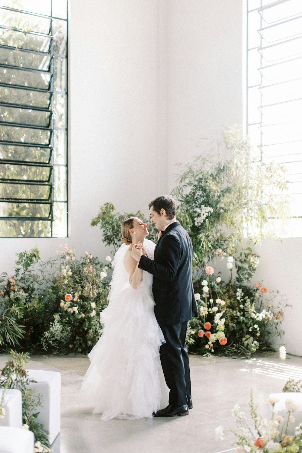 a bride and groom standing next to each other