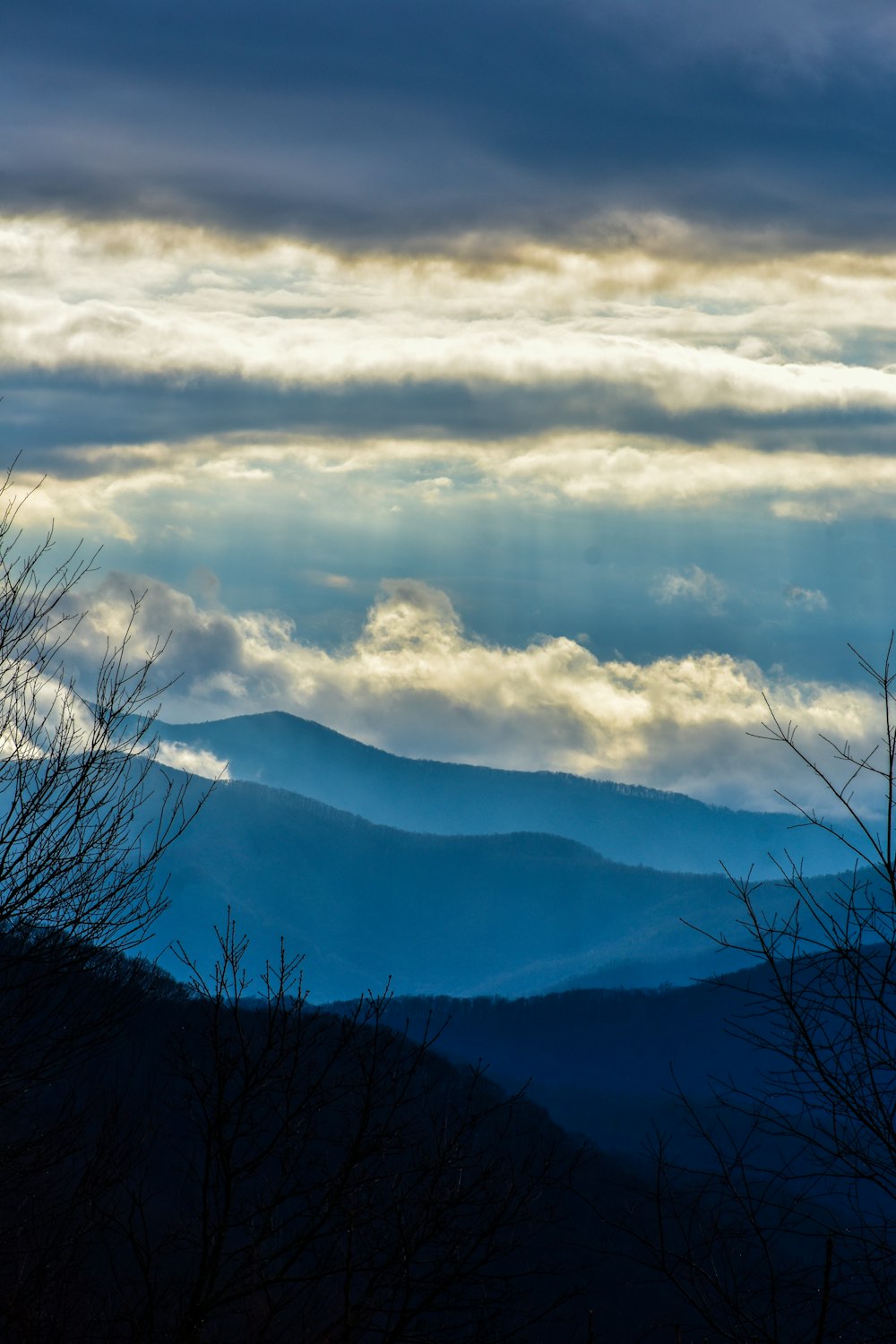 a view of a mountain range with clouds in the sky