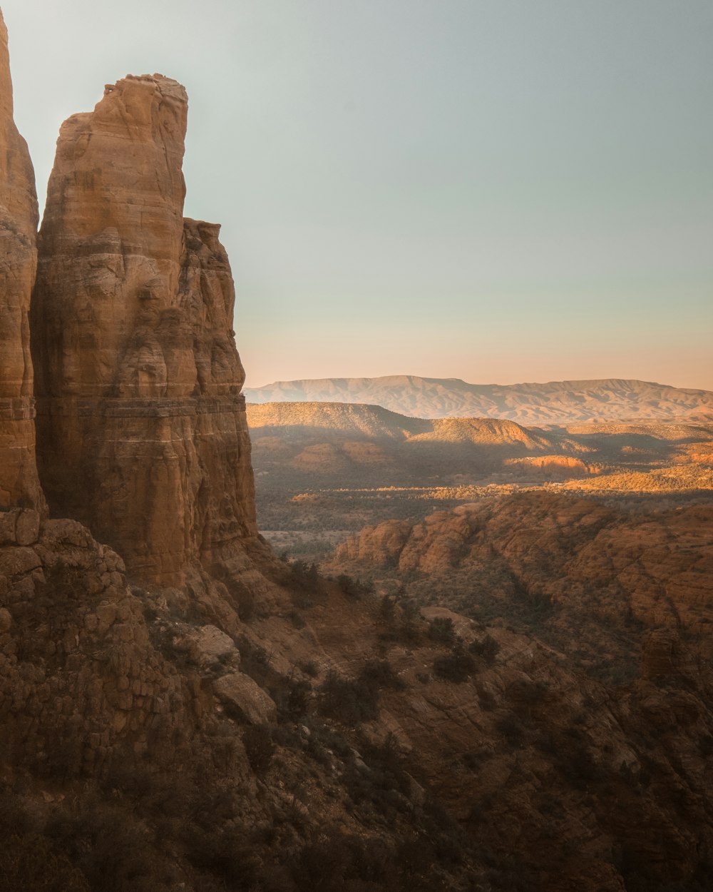 a large rock formation in the middle of a desert