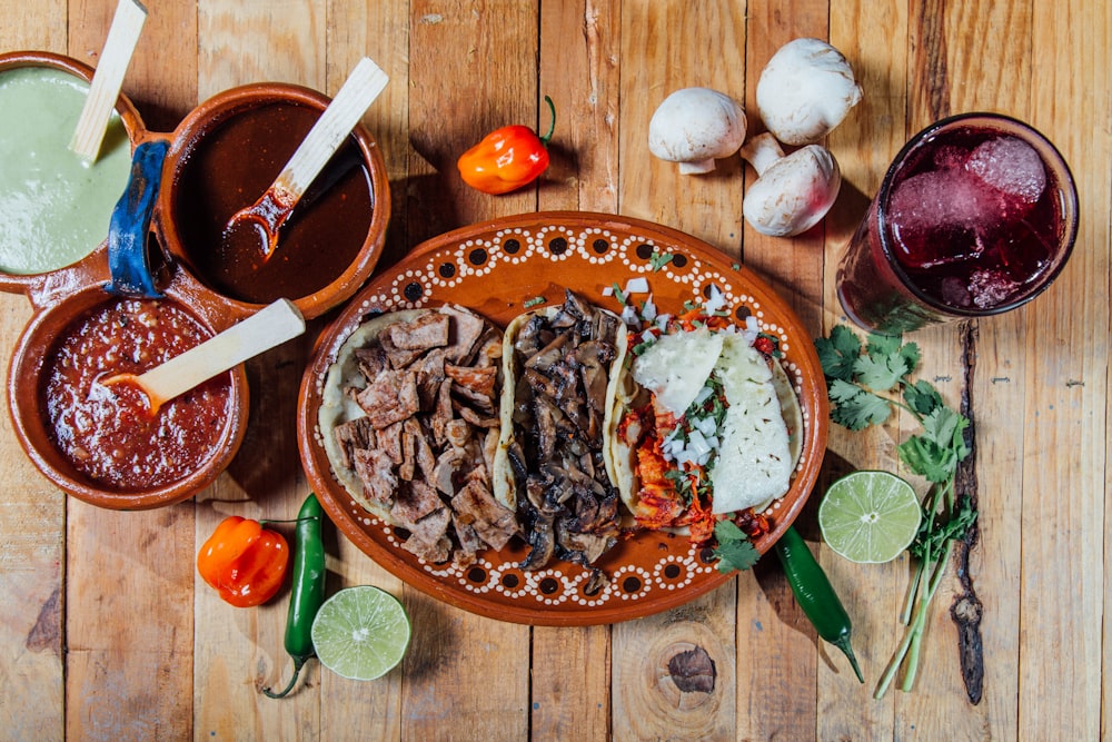 a wooden table topped with plates of food