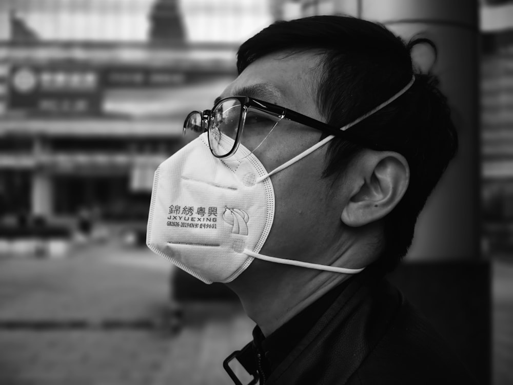 a man wearing a face mask and glasses