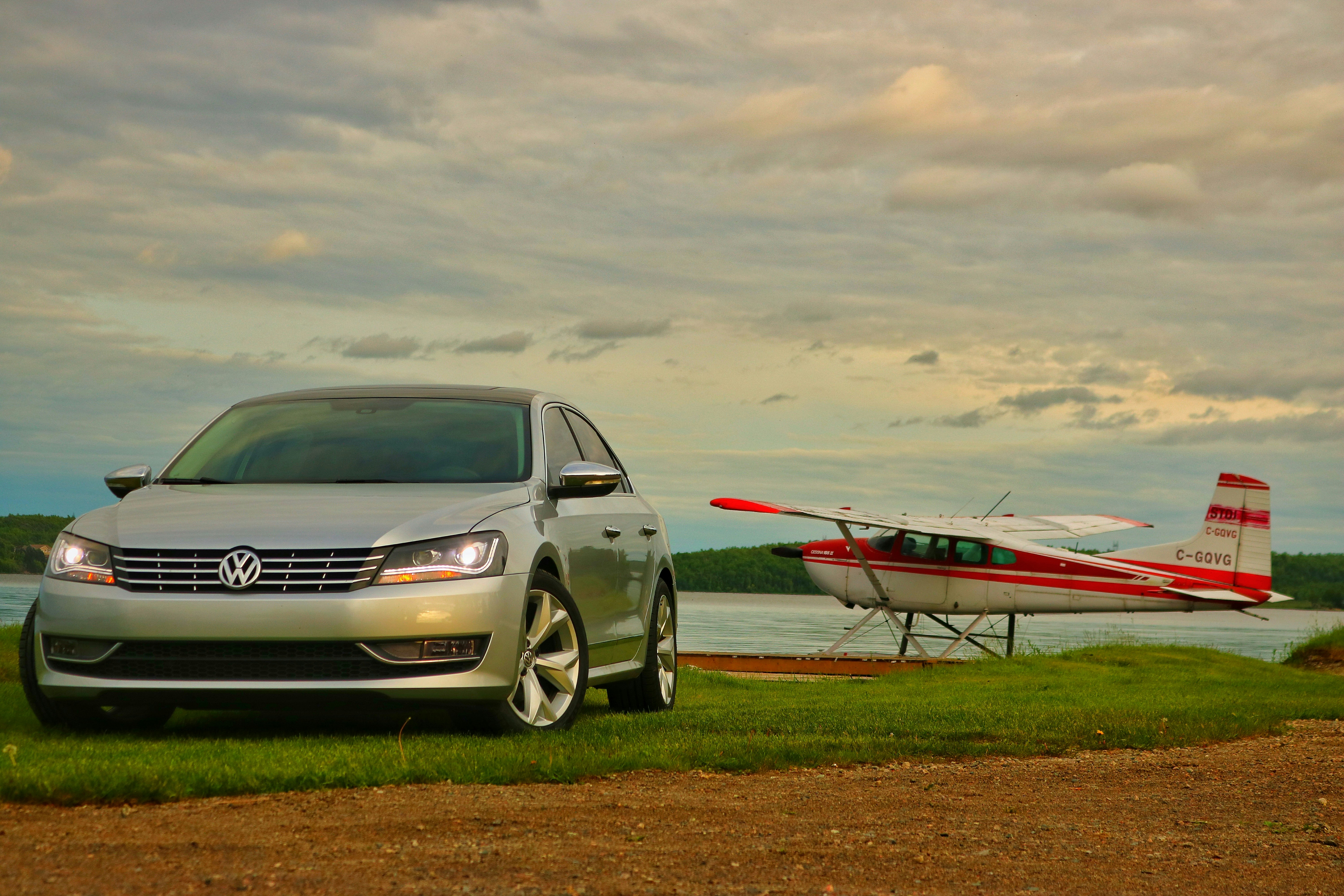 a car parked next to a small airplane