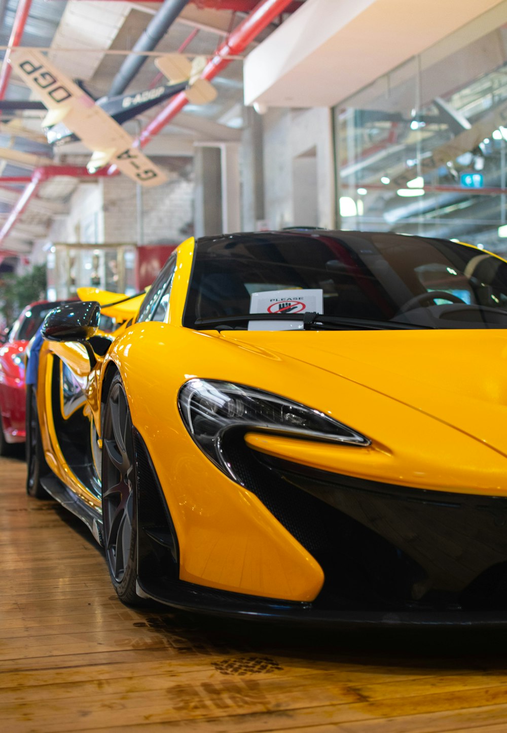 a yellow sports car parked inside of a building