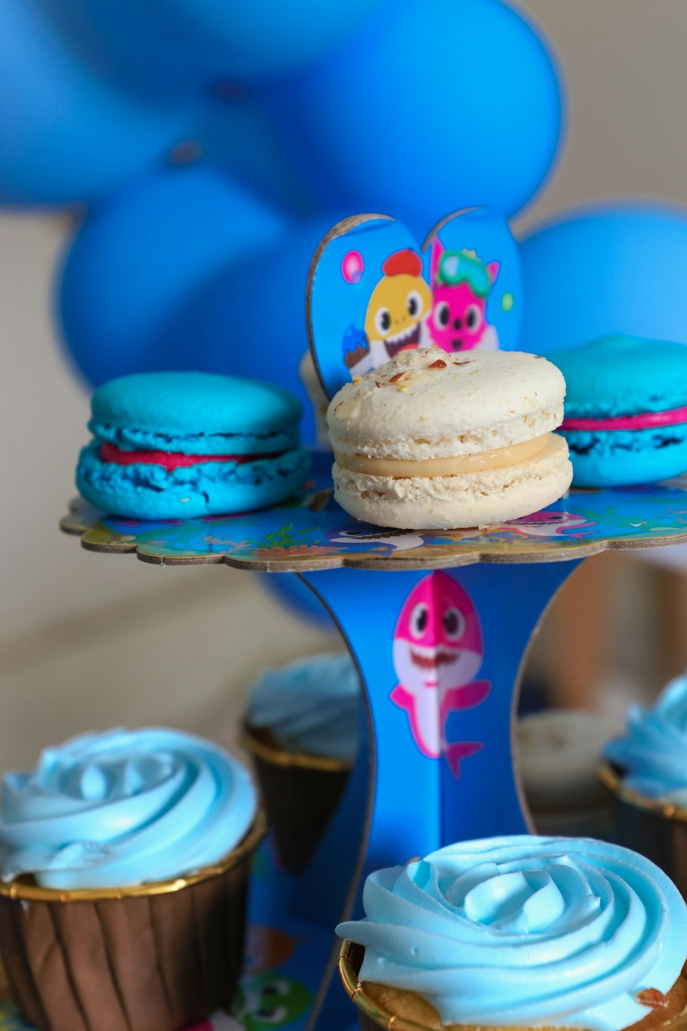 a table topped with cupcakes covered in frosting