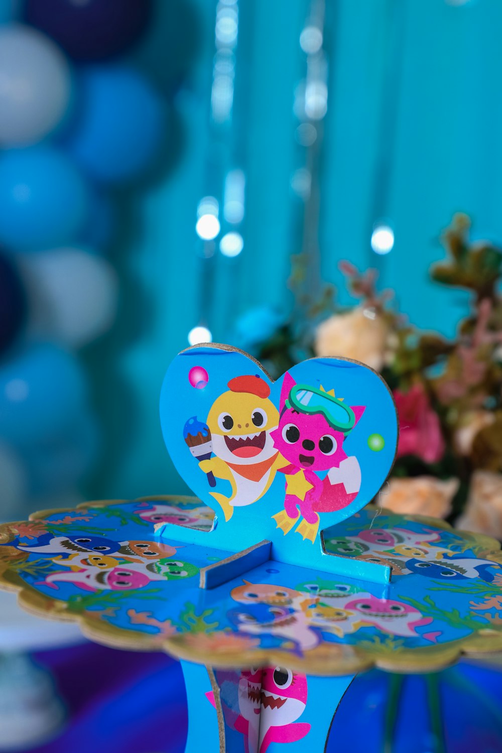 a blue cake stand with two cartoon characters on it
