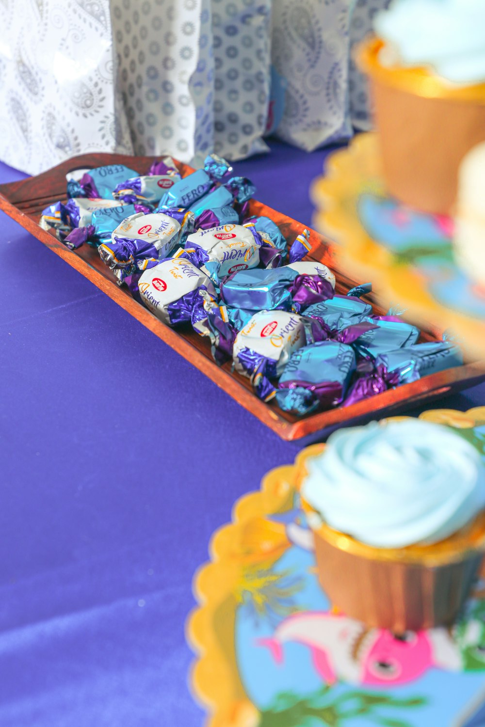 a table topped with a tray filled with lots of candy