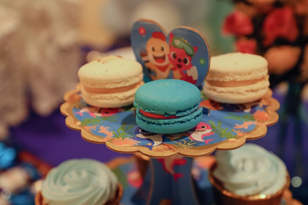 a table topped with cupcakes covered in frosting