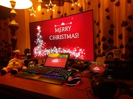 Festive holiday decorations next to a computer displaying NFT artwork creation.