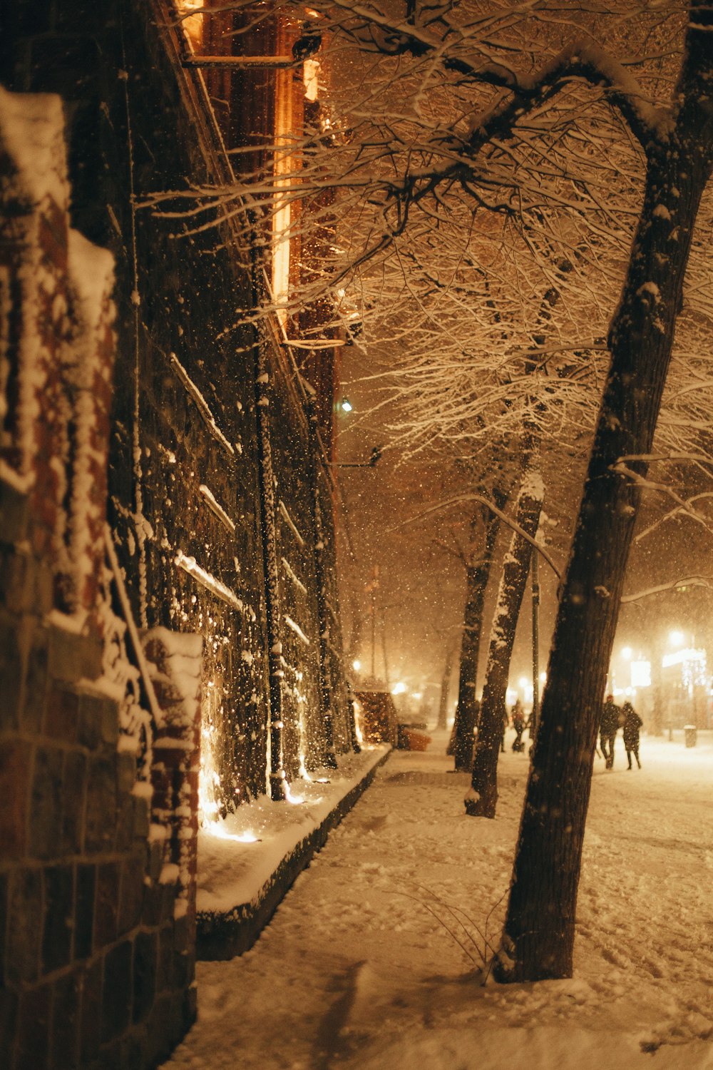 a snowy street with people walking on it