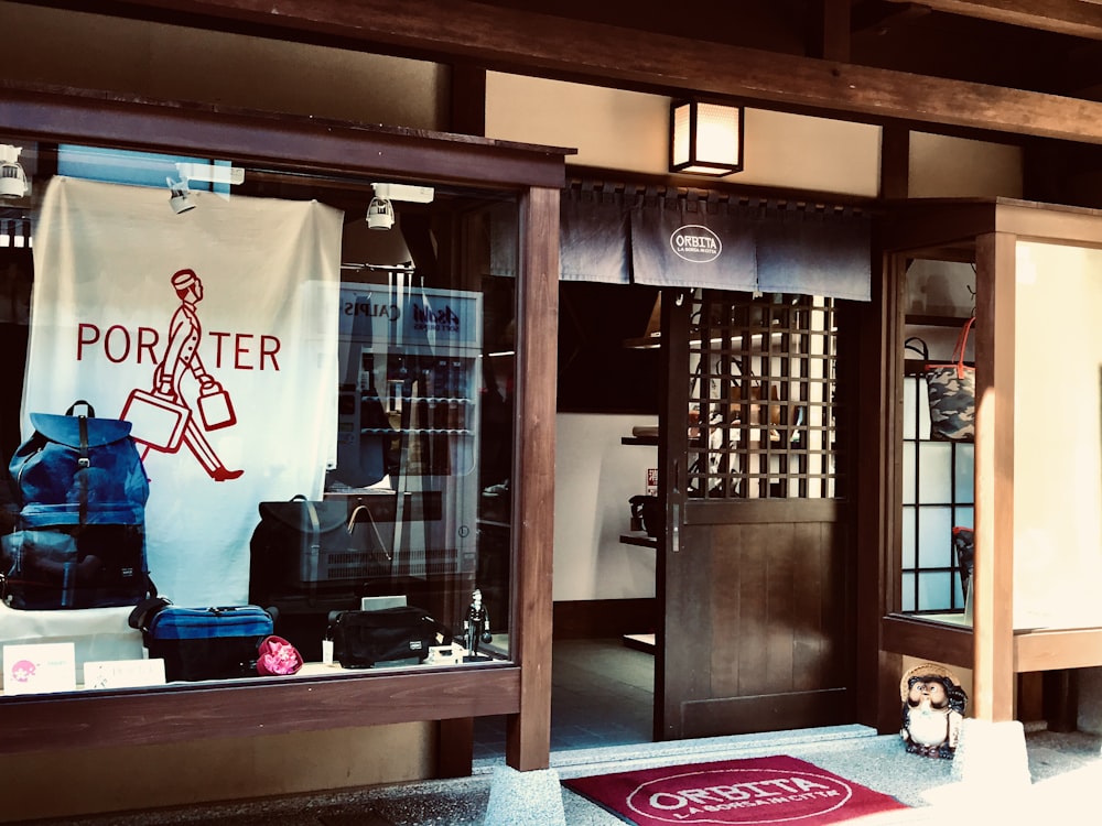 a store front with a display of luggage in the window