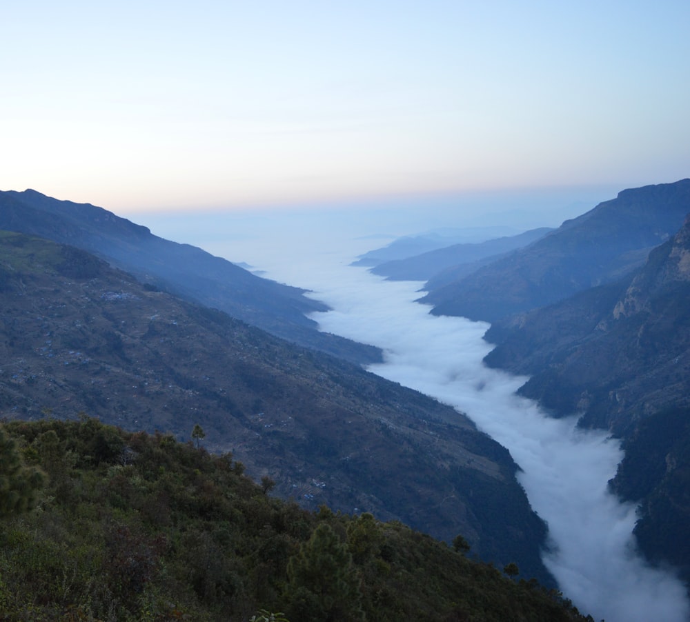 a view of a valley with a river running through it