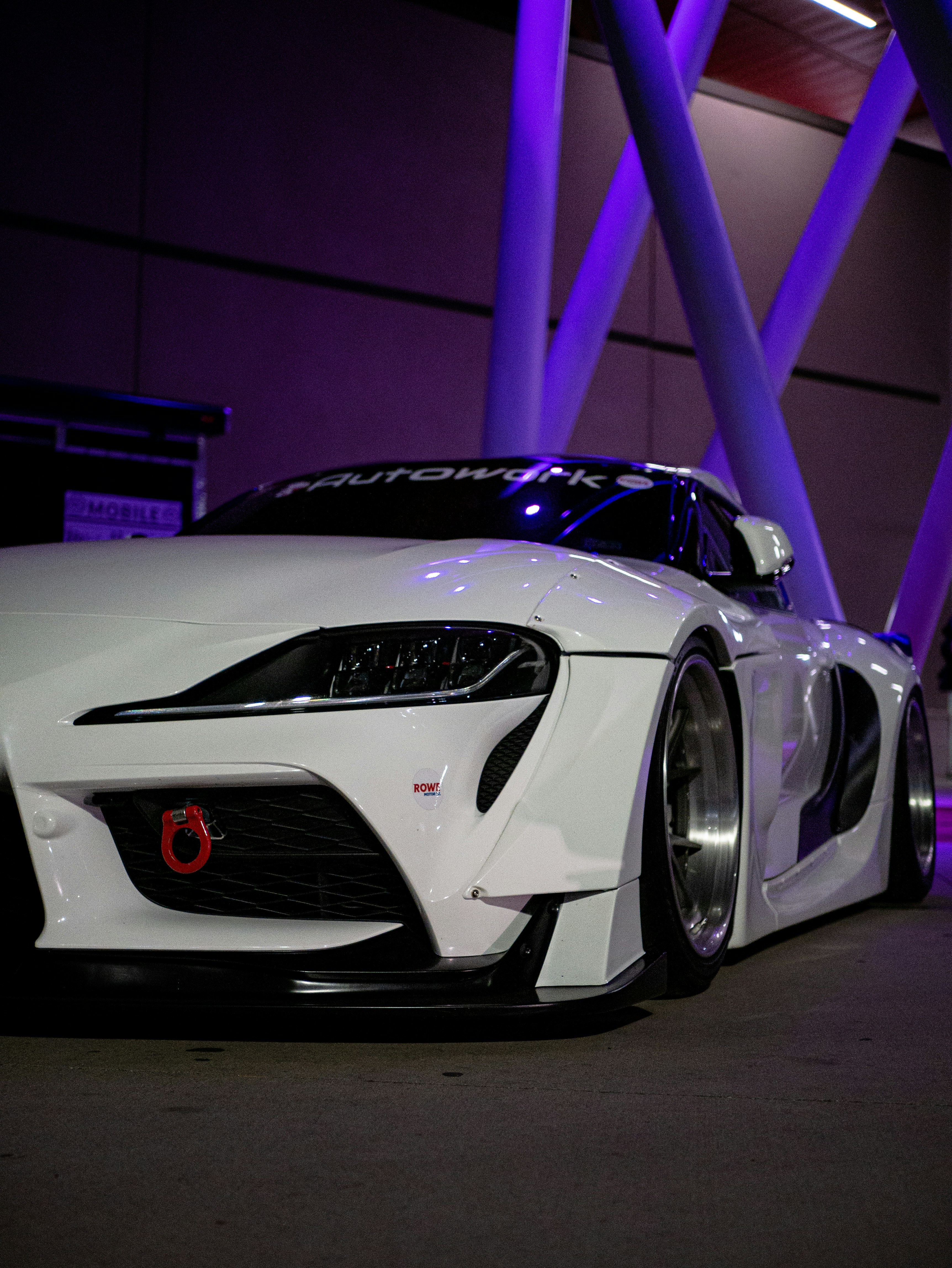 a white sports car parked in front of a building