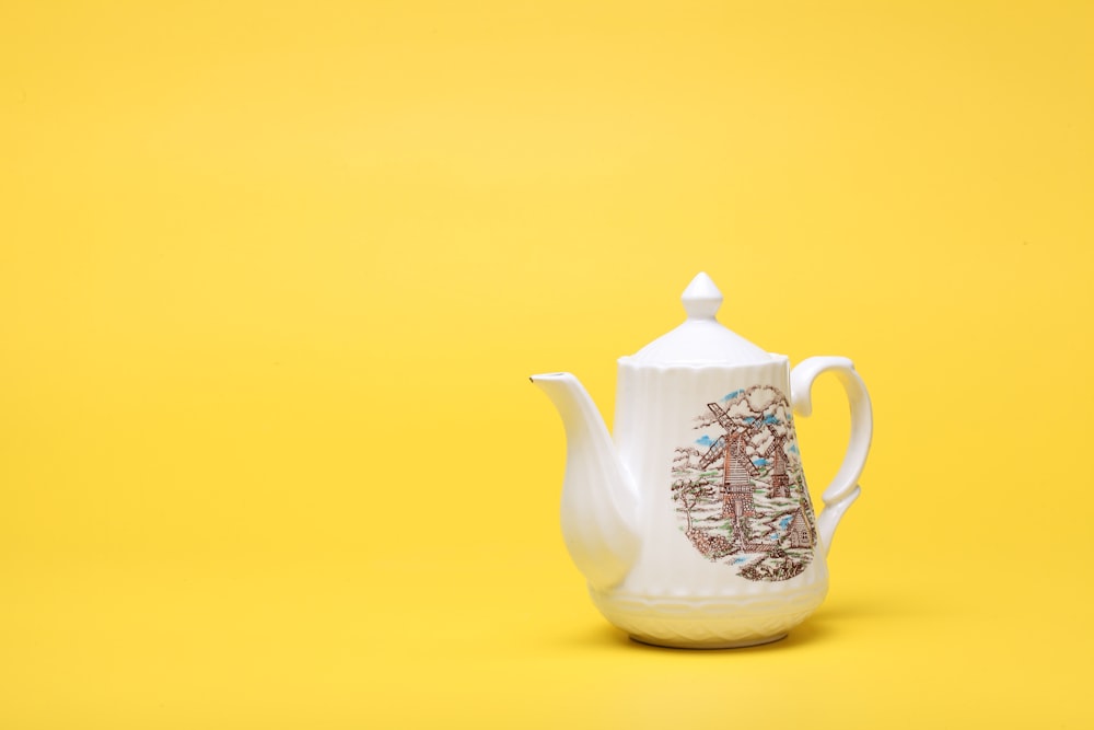 a tea pot with a picture of a man on it
