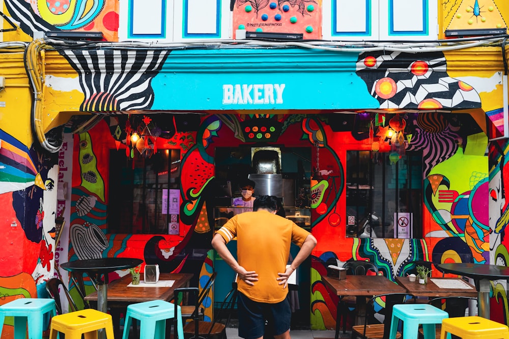 a man standing in front of a colorful building