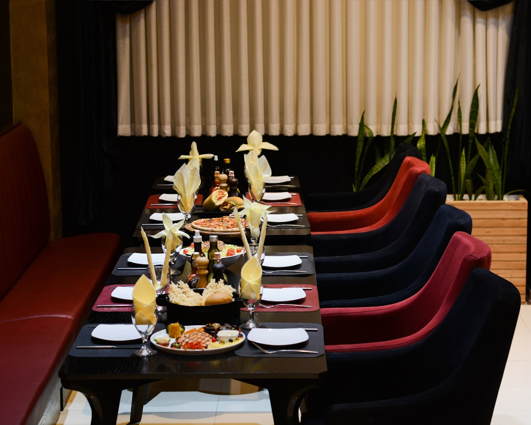 a long table with plates of food on it,