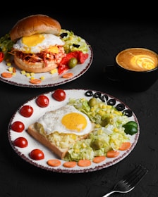 two plates of food on a table with a cup of coffee