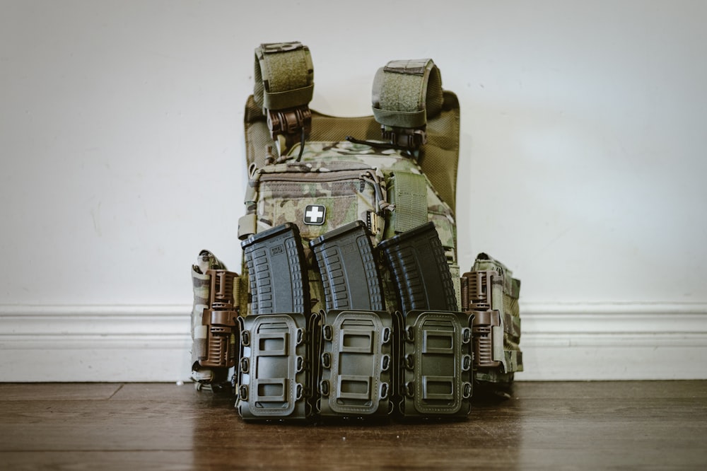 a backpack filled with magazines on a wooden floor