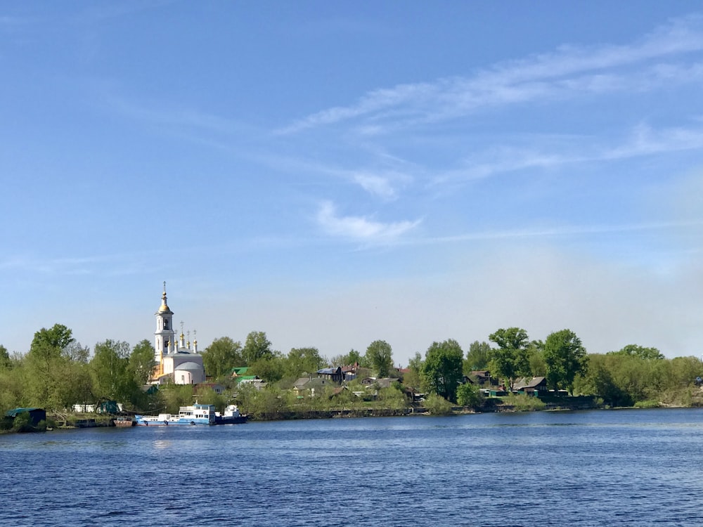 a body of water with a church in the background