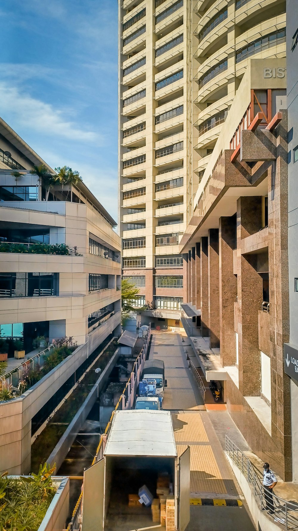 a very tall building next to a parking lot